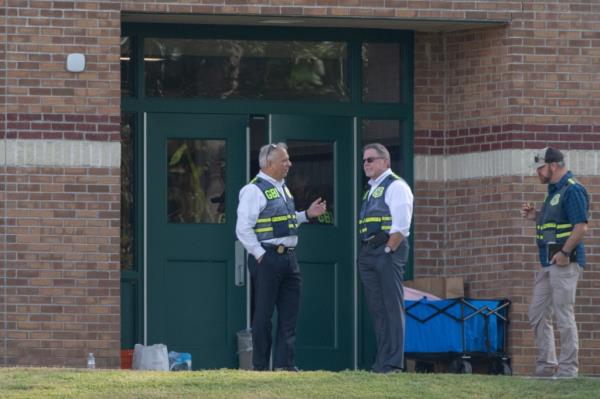 Law Enforcement agents gather at a rear door entrance at Apalachee High School after a deadly shooting that killed 4 people on Sept. 4